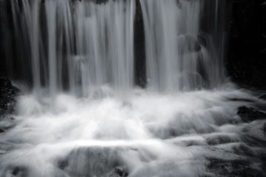 A small waterfall by a stream was exposed for a long time.