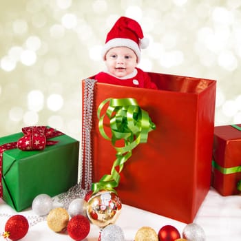 5 months old baby dressed as Santa for Christmas.