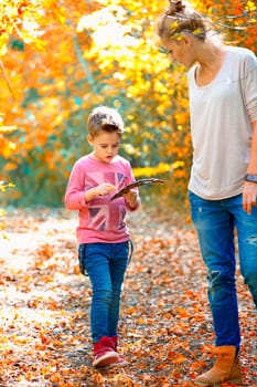 Portrait of a 5 year old boy enjoying outdoors with his mother on a fall day.