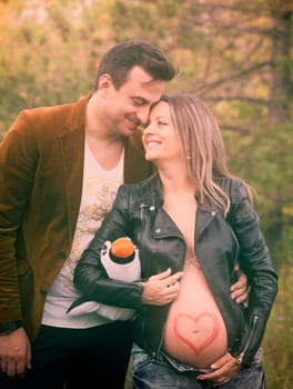 Pregnant woman with her husband relaxing outdoor.