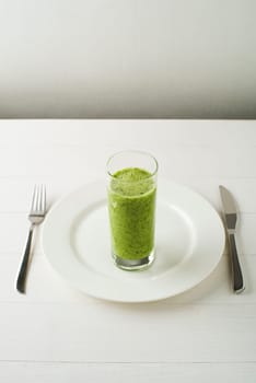 Glass of Healthy green smoothie with vegetables and fruit.