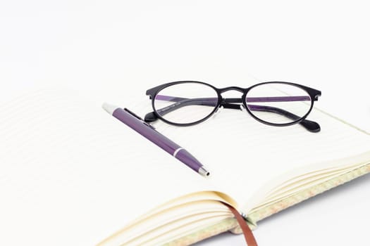 Notebook with pen isolated on white background, stock photo