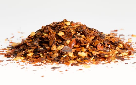 Dried Chili Pepper in a Pile close up with white background.