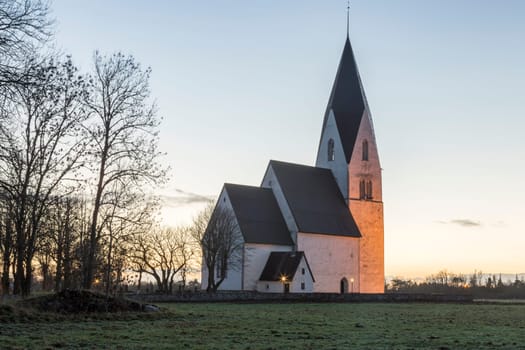 Church in Tofta, Gotland in Sweden with the pathway leading up the the church.