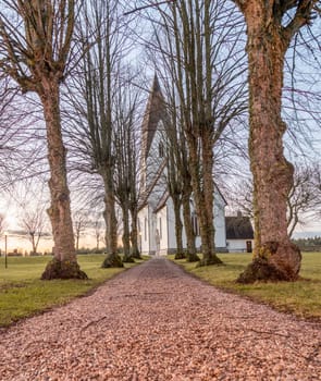 Church in Tofta, Gotland in Sweden with the pathway leading up the the church.