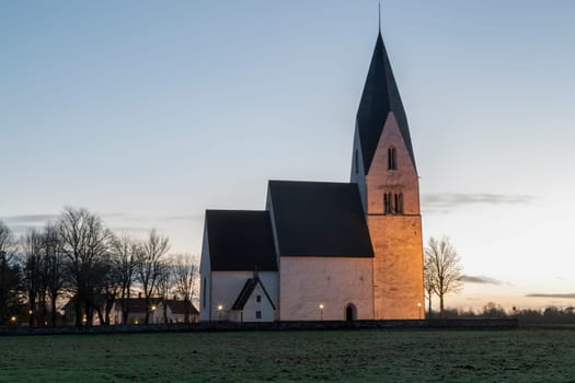 Church in Tofta, Gotland in Sweden with the pathway leading up the the church.