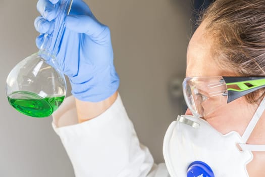 A scientist in a laboratory experiments with a liquid