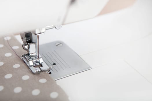 a fabric is sewn with a sewing machine,text-free space