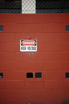 A switch house or a high-voltage system with a warning sign.