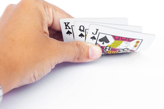 Playing cards in hand isolated on white background, stock photo