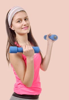 a portrait of pretty sporty girl holding weights