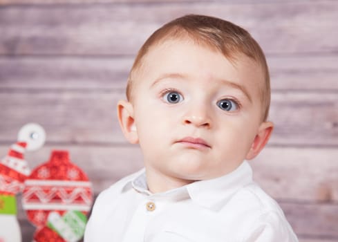 Portrait of 1 year old baby boy, Christmas theme, studio shot.