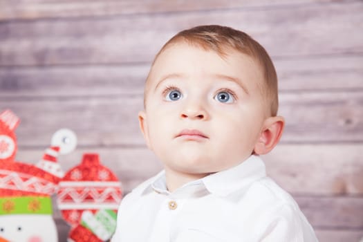 Portrait of 1 year old baby boy, Christmas theme, studio shot.