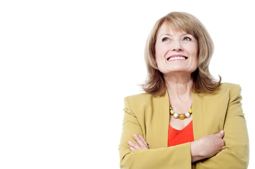 Senior woman folding arms and fond memories