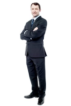 Confident business man posing with crossed arms