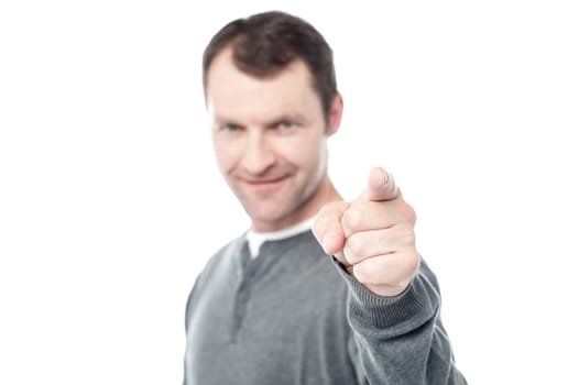 Casual man pointing his index finger towards camera