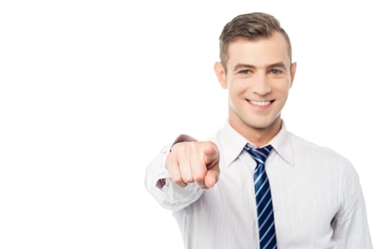 Happy businessman pointing towards the camera