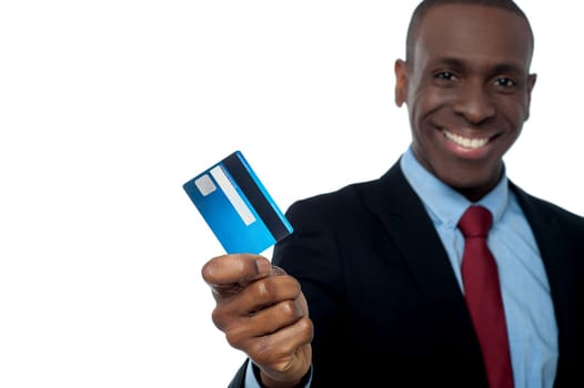 Smiling young corporate guy lending his debit card