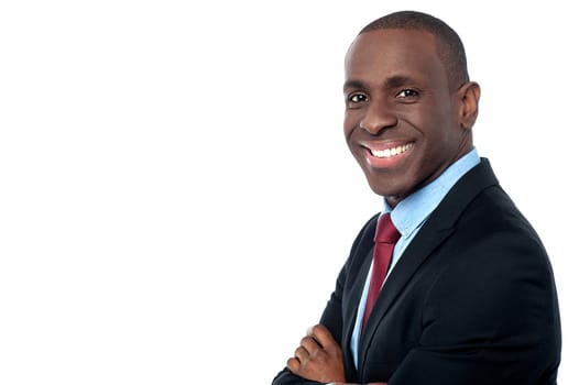 Smiling corporate man posing sideways to camera