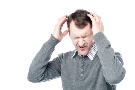 Middle Age Man with Headache Holding Head in Pain
