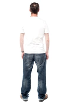 Back pose of a middle aged man facing wall