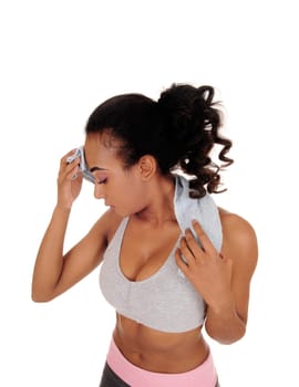 A young pretty African American woman standing in a portrait image.with a towel, sweating, isolated for white background..