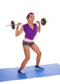 A slim and pretty African American woman lifting weight, standing isolated.for white background with the weight behind her back..