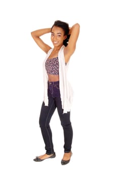 A portrait image of an African American women in a colorful top and.blue jeans standing, isolated for white background..
