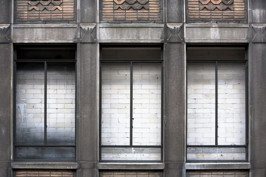 White brick wall behind windows