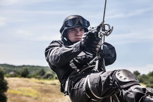 Spec ops police officer SWAT during assault operation