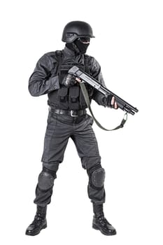 Spec ops police officer SWAT in black uniform with shotgun studio shot