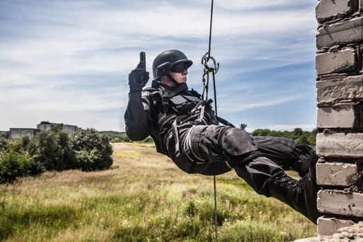 Spec ops police officer SWAT during assault operation
