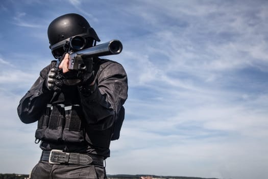 SWAT police sniper in black uniform in action