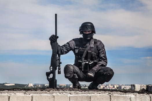SWAT police sniper in black uniform in action