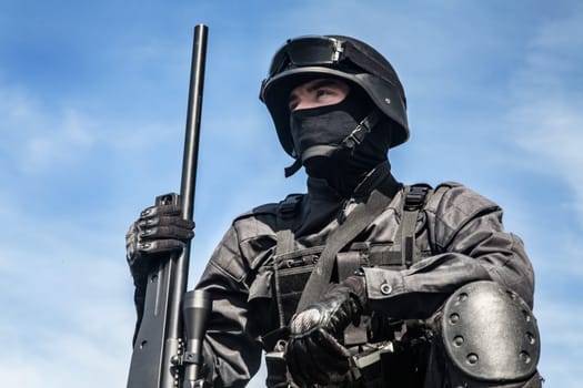 SWAT police sniper in black uniform in action