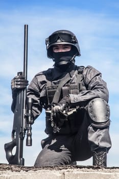 SWAT police sniper in black uniform in action