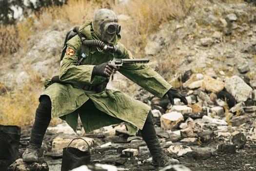 Post apocalypse. Sole survivor in tatters and gas mask on the ruins of the destroyed city