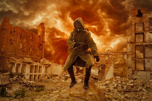 Post apocalypse. Sole survivor in tatters and gas mask on the ruins of the destroyed city