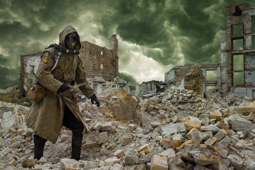 Post apocalypse. Sole survivor in tatters and gas mask on the ruins of the destroyed city