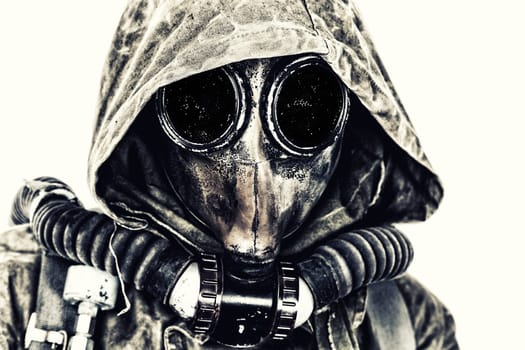 Nuclear post apocalypse. Studio shot of survivor in tatters and gas mask
