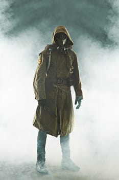 Nuclear post apocalypse. Studio shot of survivor in tatters and gas mask