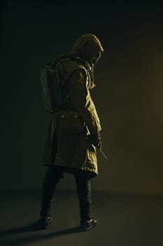 Nuclear post apocalypse. Studio shot of survivor in tatters and gas mask
