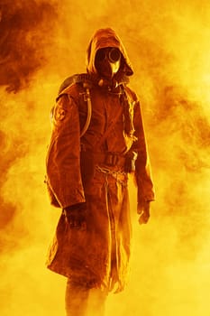 Nuclear post apocalypse. Studio shot of survivor in tatters and gas mask