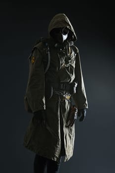 Nuclear post apocalypse. Studio shot of survivor in tatters and gas mask