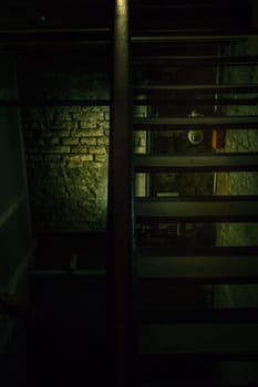 An old dangerous wooden staircase leads into the dark dungeon