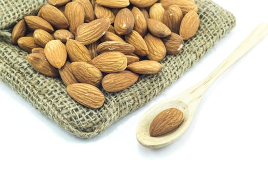 Almonds on the sack isolated on white background