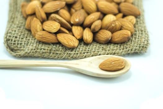 Almonds in sack isolated on white background, stock photo