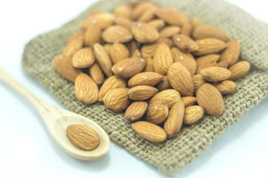 Almonds in sack isolated on white background, stock photo