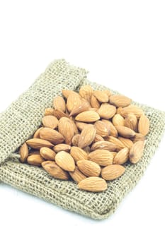 Almonds on the sack isolated on white background, stock photo