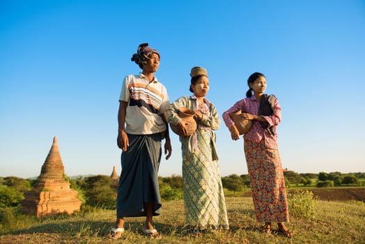 Group of Asian Burmese traditional farmers carrying clay pots going back home, Bagan, Myanmar